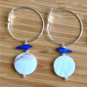 Beautiful silver plated hoop earrings! Round shell w/MOP dyed bird!